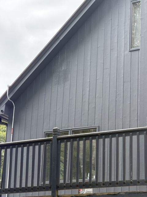 Dark gray painted siding and deck railing