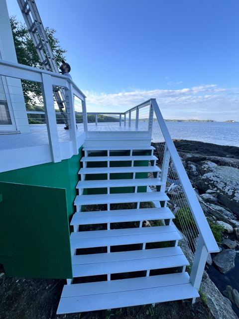 Painted white deck stairs overlooking the ocean